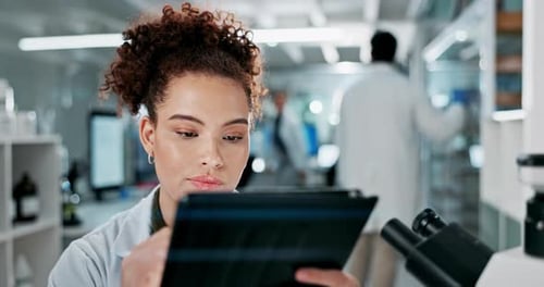 Woman Using Tablet in Bright Modern Laboratory