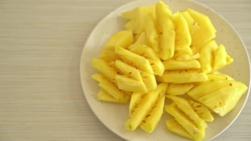 Delicious Juicy Pineapple Slices on a White Plate