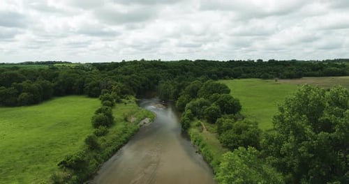 Aerial View Of River With Shallow And Clear Water Amid The Green Fields. - descend