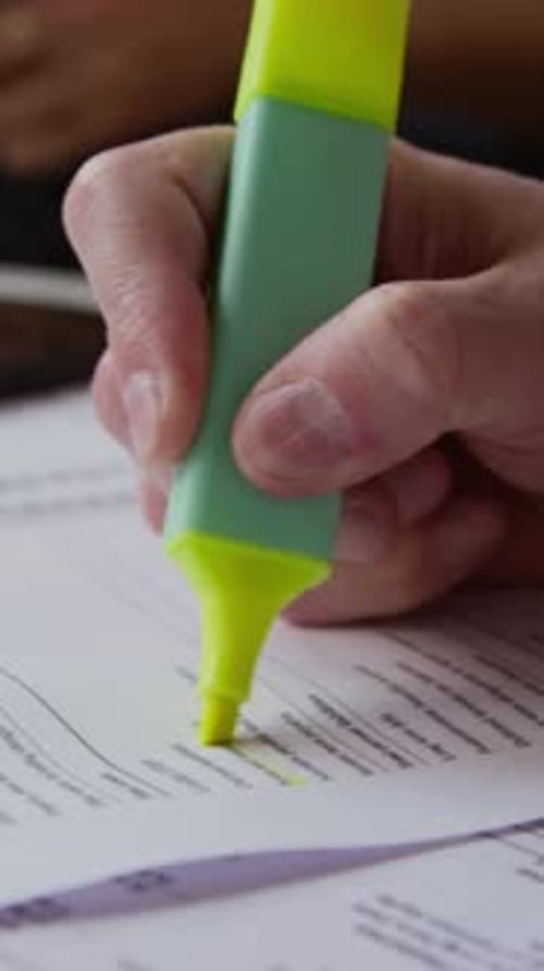 Male Hand Highlighting Lines in Contract Vertical