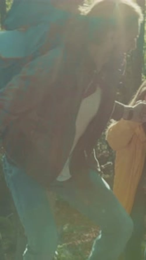 Couple Hiking and Reading a Map in Forest