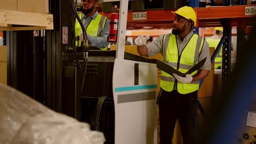 Warehouse Workers Driving Forklift Truck Operating Cardboard Boxes