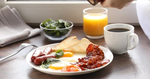 Hearty Breakfast: Eggs, Bacon, Toast, Coffee, and Juice