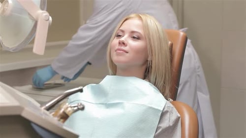 Woman Smiling in Dentist Chair During Checkup