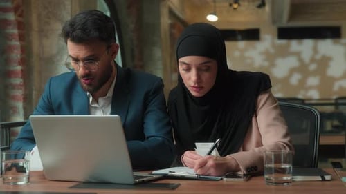 Worried Business Colleagues Discussing Finances in Modern Office