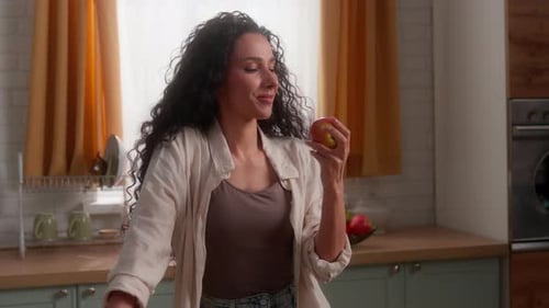 Happy Smiling Latina Woman Throwing Apple Biting Looking at Camera Eating Fruit Hispanic Caucasian