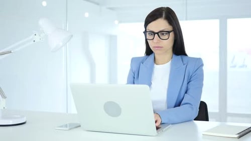Businesswoman Reacts in Shock at Her Laptop
