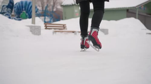 Woman ice skating at outdoor winter ice rink