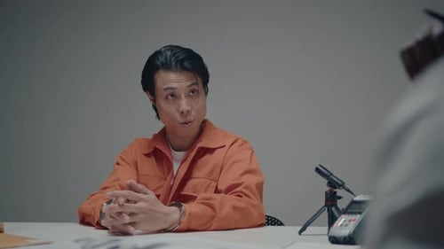 Arrested Villain Talking to Police Officer during Interrogation