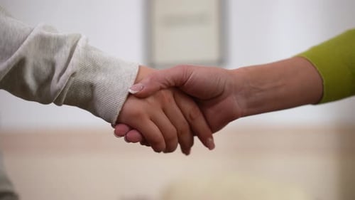 Adult Comforting Child Hand Squeeze Close Up