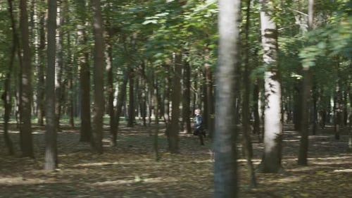 Runner Sprinting Through Sunlight Dappled Forest