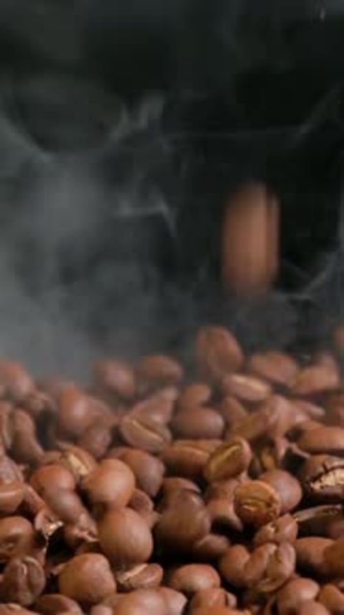 Steaming Roasted Coffee Beans Falling in Slow Motion