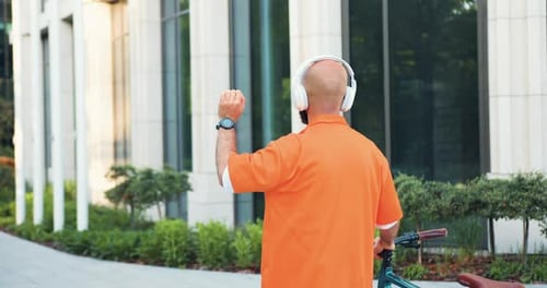 Adult With Bicycle Taps Smartwatch