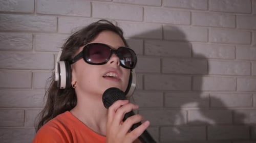 Energetic Child Sings with Microphone and Headphones