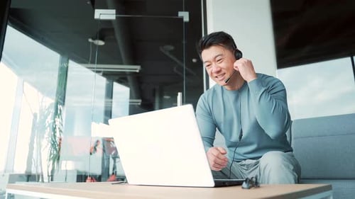 Asian male freelancer talking to colleagues in meeting room at modern office coworking. Business man