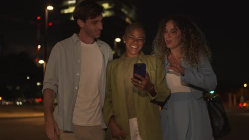 Friends Laughing and Talking While Looking at Phone