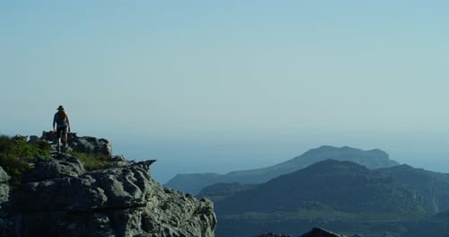Success, hiking or person in celebration on mountain peak in nature adventure walking outdoors