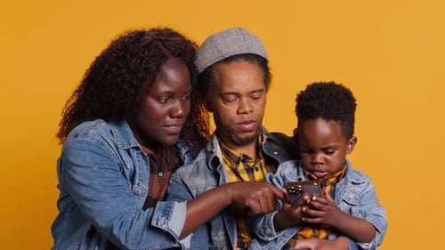 Happy Family Looking at Smartphone