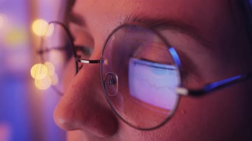 Trader Woman Wearing Glasses Working on Laptop Closeup Footage Screen with Stock Market Charts and