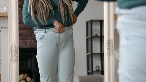 Closeup of Chubby Woman Trying to Fit Into Tight Pants After Gaining Weight