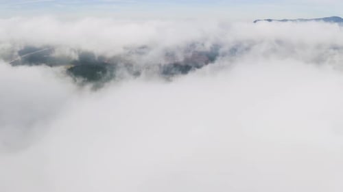 4k drone footage of clouds high above a mountainous area