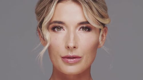 Studio Portrait of Young and Beautiful Blond Woman Over Grey Background Skin Care and Wellness