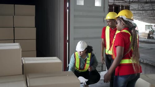 Blue collar workers working at warehouse.