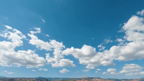 Clouds Moving Across Bright Blue Daytime Sky
