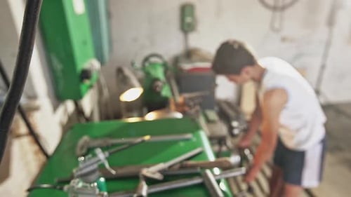 Teenager Operating Metal Lathe in Workshop