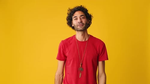 Man Celebrates with Fists Raised on Yellow Background
