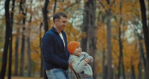 Happy Father and Son in Park in Autumn Day Dad Whirling Little Boy in Arms Prores