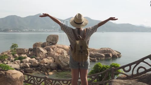Woman enjoying coastal views, freedom, relaxing in nature