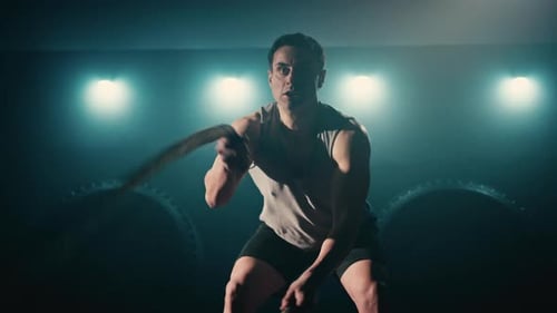 Muscular Man Doing Battle Rope Workout