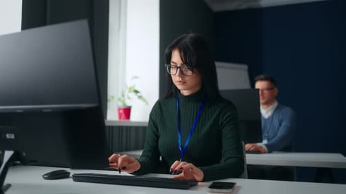 Young Female Data Scientist and Analyst Working in Office Portrait of Woman at Table with Computer
