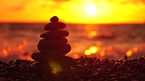 Balanced Rock Pyramid on Pebbles Beach Sunny Day and Clear Sky at Sunset