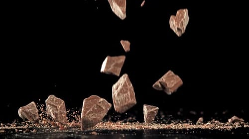 Pieces of Chocolate Fall on the Table Filmed on a Highspeed Camera at 1000 Fps
