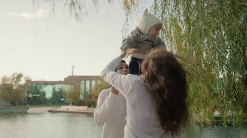 Couple and Child By Lake Happy Family Moment with Child at Lakeside During Autumn Joyful Family