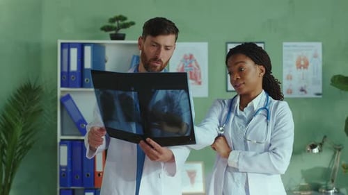 Doctors Reviewing X-Ray Image in Medical Office