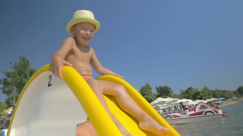 Child riding on slider at seaside