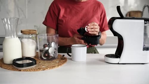 Woman Makes Coffee With Pod Machine in Kitchen