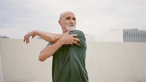 Man Stretches his Arm on Cloudy Day