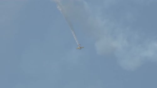Small Airplane Performing Stunts with Smoke Trail