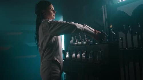 Foil Fencer Taking Rapier Before Fencing Training in Smokey Hall