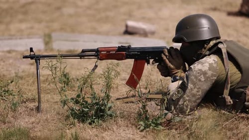 Defending Nation in Green Uniform Vest with a Machine Gun in Hand Soldier Holding a Gun Military