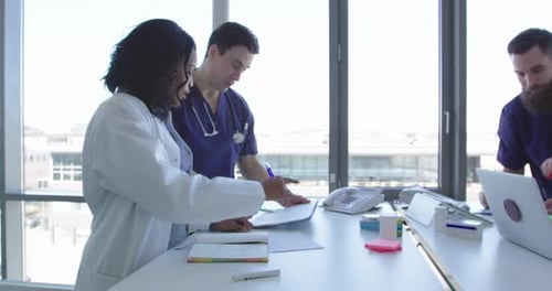 Medical Professionals Collaborating on Patient Care in Modern Office