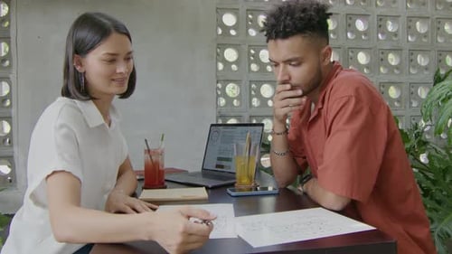 Business People Discussing Project in Coworking Cafe