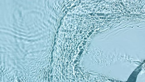 Pure Water with Reflections Sunlight in Slow Motion Water Surface Texture Top View Sun and Shadows