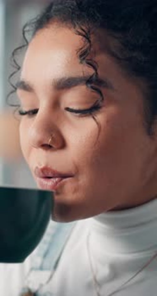 Smiling Woman Drinks Beverage from Mug Close-Up