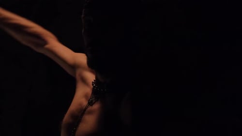 Close-up of a fire performer spinning a lit dragonstaff.