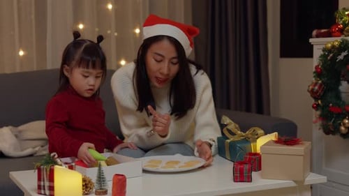 Mother and Child Decorating Christmas Cookies at Home